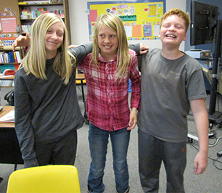 Three students with arms around each other