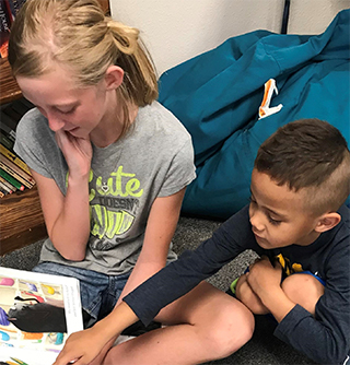 Students reading picture book together