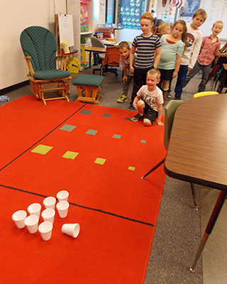 Students playing game with cups
