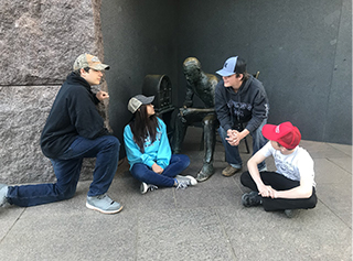 Students sitting with statues 